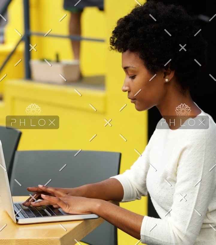 attractive-young-woman-using-laptop-outside-P9RLFGU